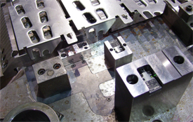 use of channels milled directly withn the die plate and protected with carefully machined steel covers