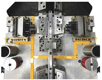 Two separate cams monitored for their respective returns with one inductive proximity sensor per cam